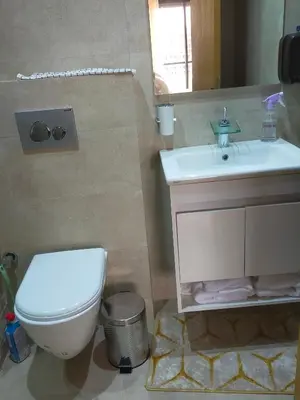 a bathroom with a white toilet and a sink at CASABLANCA BORD dE MER A 200 m DE LA PLAGE Appartement Haut de gamme 2 Chambres avec 2 Salles de bain Piscine Salle de Sport plage in Casablanca