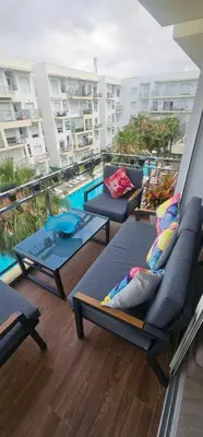 a balcony with lounge chairs and a swimming pool at Appartement vue sur piscine kettani in Bouznika