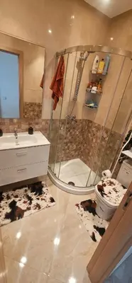 a bathroom with a shower and a toilet and a sink at Appartement vue sur piscine kettani in Bouznika