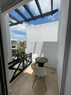 a balcony with a table and two chairs on it at Sun Darb in Dar Bouazza