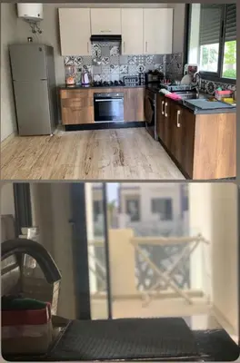 a kitchen with a refrigerator and a counter top at Dar Bouazza Plage in Dar Bouazza