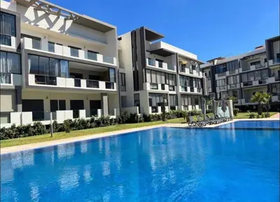 a large swimming pool in front of a building at Dar Bouazza Plage in Dar Bouazza