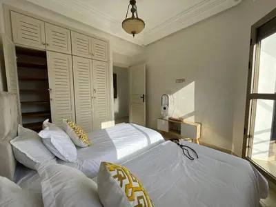 a bedroom with two beds with white sheets and pillows at MTL 33 Casablanca city center in Casablanca