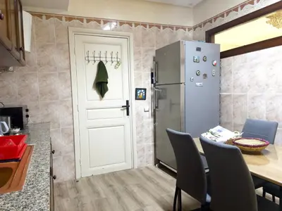 a kitchen with a table and a refrigerator at MTL 33 Casablanca city center in Casablanca