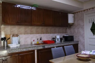 a kitchen with wooden cabinets and a counter top at MTL 33 Casablanca city center in Casablanca