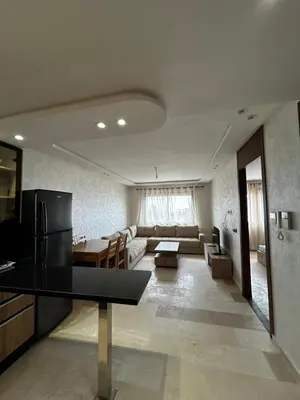 a large living room with a couch and a table at Nouvel Appartement Parc Mohammedia in Mohammedia