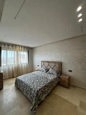 a bedroom with a large bed and a large window at Nouvel Appartement Parc Mohammedia in Mohammedia