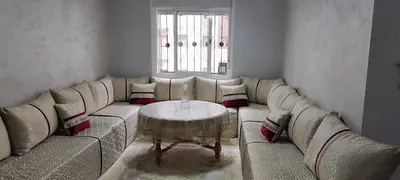 a living room with a couch and a table at Appartement calme absolu in Casablanca