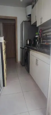 a kitchen with a stove and a refrigerator at Appartement calme absolu in Casablanca