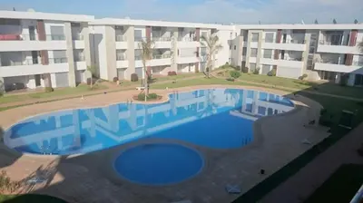 a large swimming pool in front of a building at Bahía Golf Beach BOUZNIKA in Bouznika