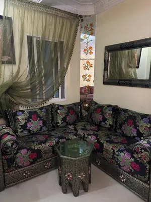 a living room with a couch and a table at Calme, plage 8 min, tout proche in Temara