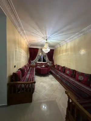 a large room with red chairs and a table at Calme, plage 8 min, tout proche in Temara