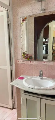 a bathroom with a sink and a mirror at Calme, plage 8 min, tout proche in Temara