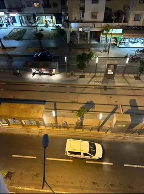 a city street at night with cars on the road at Superb appartement moyen standing au cœur de Aïn Sebàa in Casablanca