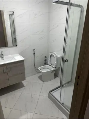 a bathroom with a toilet and a sink and a shower at Superb appartement moyen standing au cœur de Aïn Sebàa in Casablanca