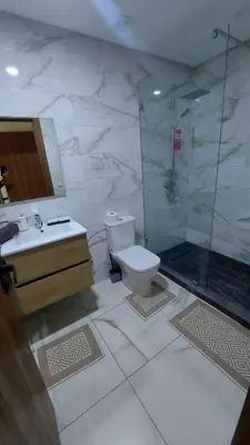 a bathroom with a toilet and a shower and a sink at Sublime appartement à MANSOURIA in Mansouria