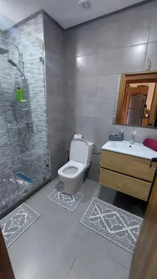 a bathroom with a shower and a toilet and a sink at Sublime appartement à MANSOURIA in Mansouria