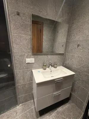 a bathroom with a sink and a mirror at Appartement chic Rabat in Rabat