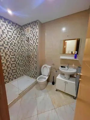 a bathroom with a toilet and a sink and a shower at Appartement Cosy & Calme avec Piscine, Tamaris Dar Bouazza in Tamaris