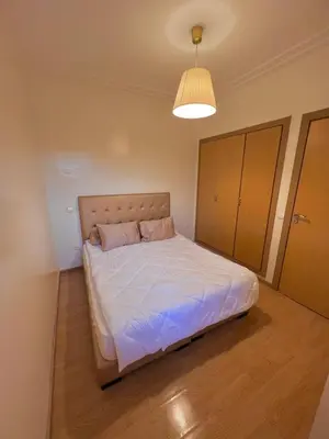 a bedroom with a large bed in a room at Appartement Cosy & Calme avec Piscine, Tamaris Dar Bouazza in Tamaris