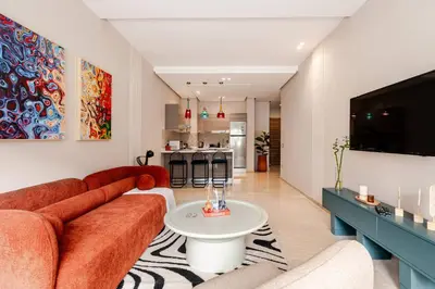 a living room with a couch and a tv at 5 min from airport, 1 bedroom, balcony, pools in Nouaceur