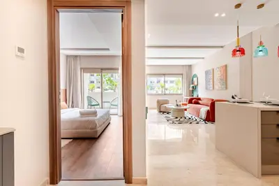 a bedroom with a bed and a living room at 5 min from airport, 1 bedroom, balcony, pools in Nouaceur
