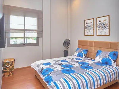 a bedroom with a bed with blue flowers on it at Appartement haut standing in Casablanca