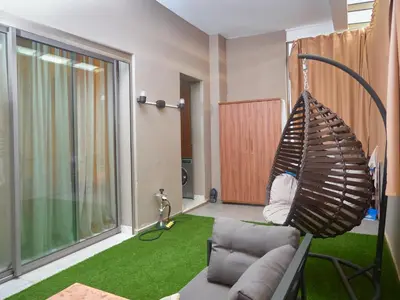 a living room with a couch and green carpet at Appartement haut standing in Casablanca
