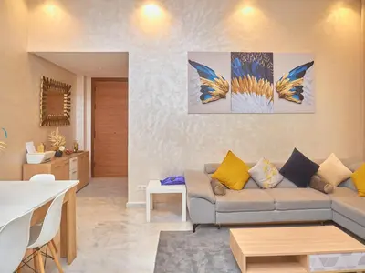 a living room with a couch and a table at Appartement haut standing in Casablanca