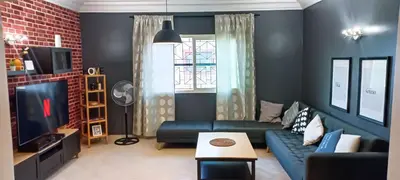 a living room with a couch and a tv at Budget-Friendly Apartment Near AirPort in Nouaseur