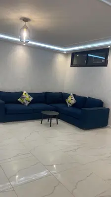 a living room with a blue couch and a table at Villa oued cherrat bouznika 3 bedrooms in Bouznika