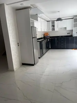 a large kitchen with a white tile floor at Villa oued cherrat bouznika 3 bedrooms in Bouznika