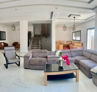 a living room with a couch and a table at Villa oued cherrat bouznika 3 bedrooms in Bouznika