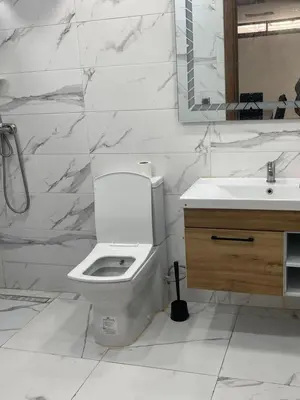 a white bathroom with a toilet and a sink at Villa oued cherrat bouznika 3 bedrooms in Bouznika