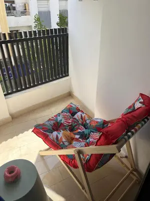 a bed sitting on a chair in a room at Cosy Studio Plein Casablanca in Casablanca