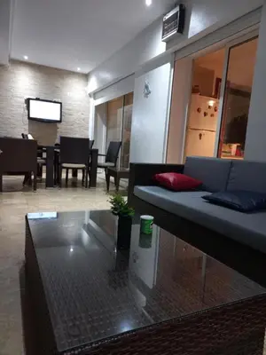 a living room with a couch and a table at Berrada in Dar Mohammed Ould Haj Jilali