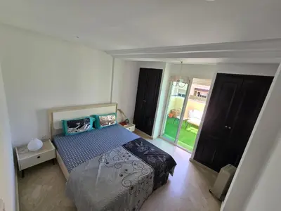 a bedroom with a bed and a large window at Appartement cosy en plein quartier d'affaires in Casablanca