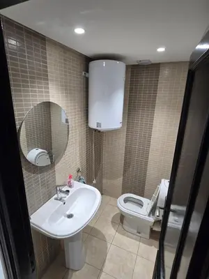 a bathroom with a sink and a toilet and a mirror at Appartement cosy en plein quartier d'affaires in Casablanca