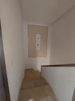 a stairway with a light switch on the wall at Duplex de Luxe avec Vue Mer a Zenata City-Eco in Aïn Harrouda