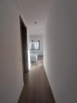 an empty room with a door leading to a bedroom at Duplex de Luxe avec Vue Mer a Zenata City-Eco in Aïn Harrouda