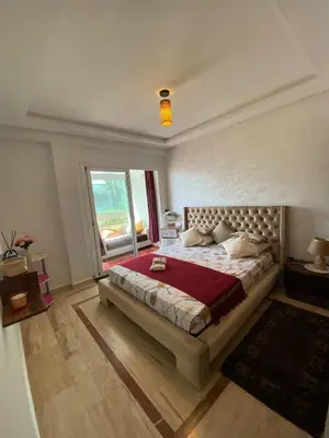 a bedroom with a large bed with a red blanket at Élégance Océanique in Casablanca