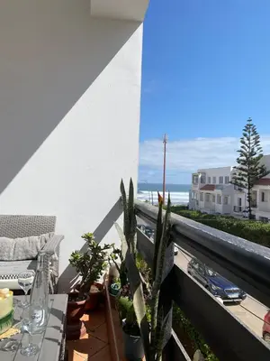 a balcony with potted plants and a view of the ocean at Élégance Océanique in Casablanca