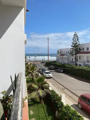 a view of a street with cars parked on the road at Élégance Océanique in Casablanca
