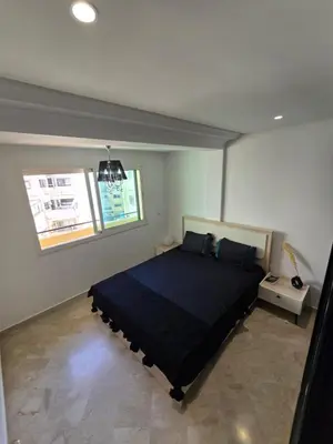 a bedroom with a bed in a room with a window at Appartement cosy au centre de casablanca in Casablanca