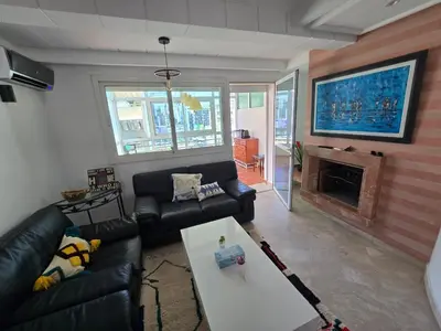 a living room with a couch and a fireplace at Appartement cosy au centre de casablanca in Casablanca