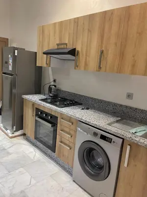 a kitchen with a washing machine and a stove at Ocean park , for married couples and families only , Luxury fully furnished one bedroom flat next to zenata beach with five avialable swimming pool at the compound in Casablanca