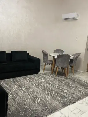 a living room with a couch and a table and chairs at Ocean park , for married couples and families only , Luxury fully furnished one bedroom flat next to zenata beach with five avialable swimming pool at the compound in Casablanca