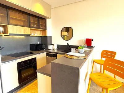 a kitchen with a counter and chairs in it at Casa Tina in Casablanca