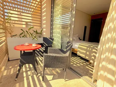 a balcony with a table and chairs and a bed at Casa Tina in Casablanca