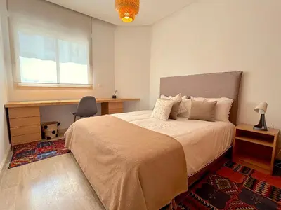 a bedroom with a bed and a desk and a window at Casa Sahifa in Casablanca